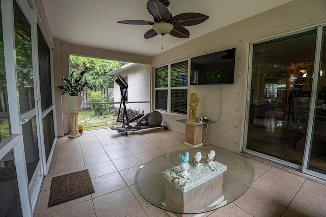 sunroom featuring a ceiling fan