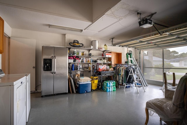 garage featuring a garage door opener, independent washer and dryer, and stainless steel refrigerator with ice dispenser