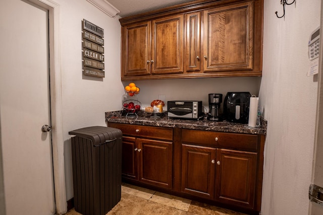 kitchen with radiator and dark stone countertops