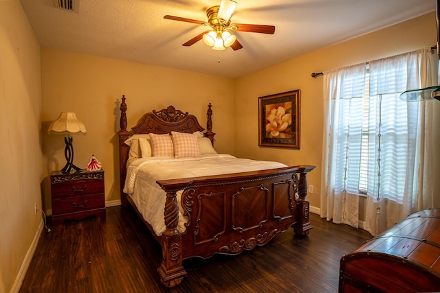 bedroom featuring dark wood-style floors, multiple windows, and visible vents