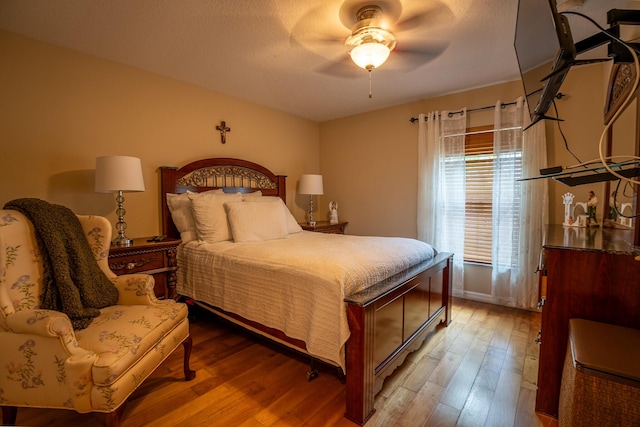 bedroom featuring ceiling fan, a textured ceiling, and wood finished floors