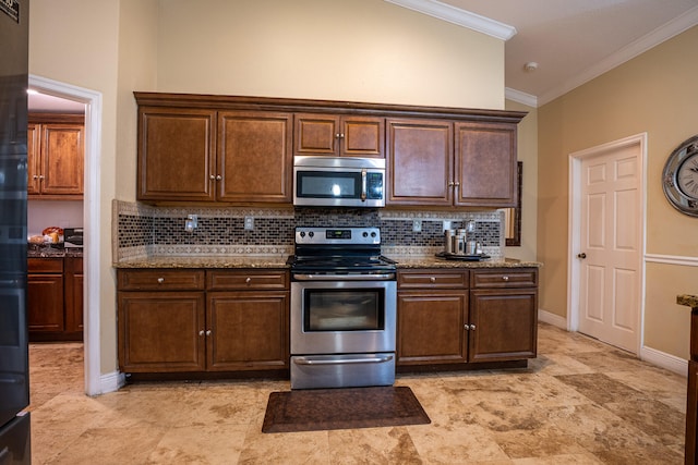 kitchen featuring light stone countertops, ornamental molding, stainless steel appliances, and backsplash