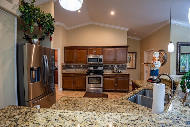 kitchen with pendant lighting, stainless steel appliances, a sink, decorative backsplash, and crown molding