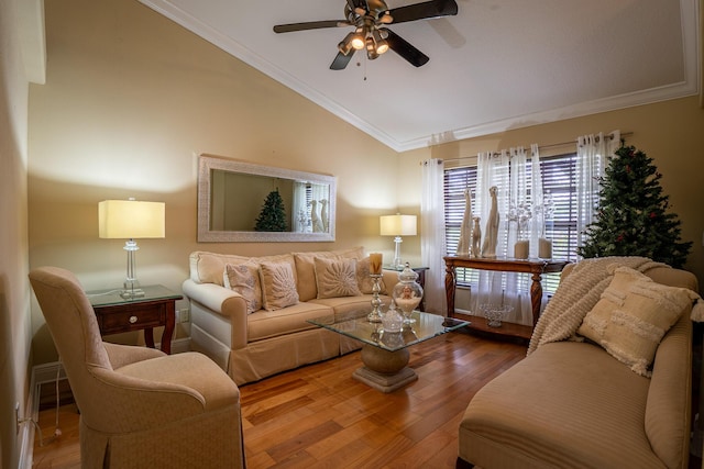 living area with crown molding, a ceiling fan, vaulted ceiling, and wood finished floors