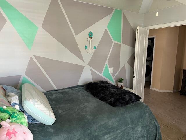 bedroom with lofted ceiling and tile patterned flooring