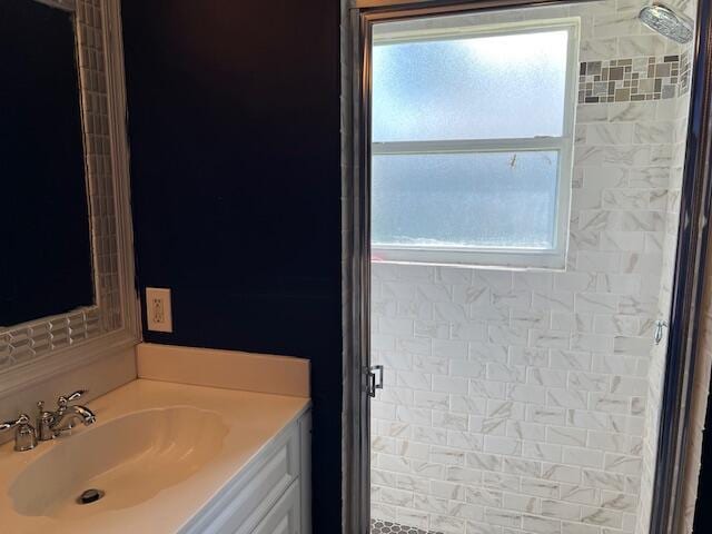 bathroom with walk in shower and vanity