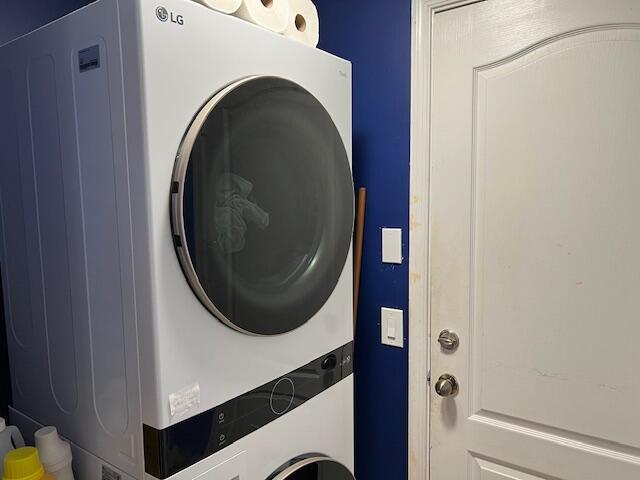 laundry room featuring laundry area and stacked washer and clothes dryer