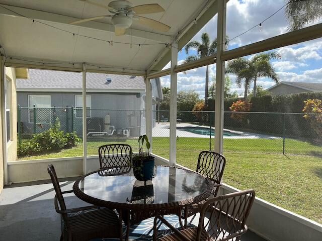 sunroom with a ceiling fan