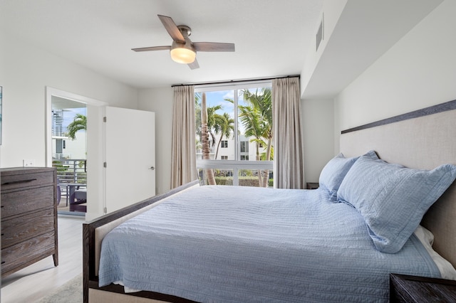 bedroom featuring light wood-style floors, multiple windows, and a ceiling fan