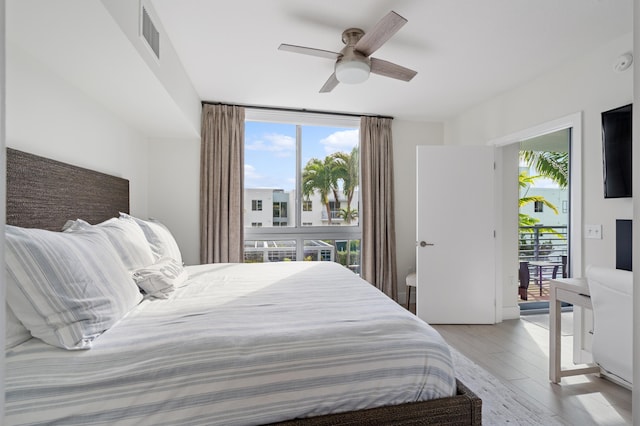 bedroom with light wood-style floors, ceiling fan, multiple windows, and visible vents