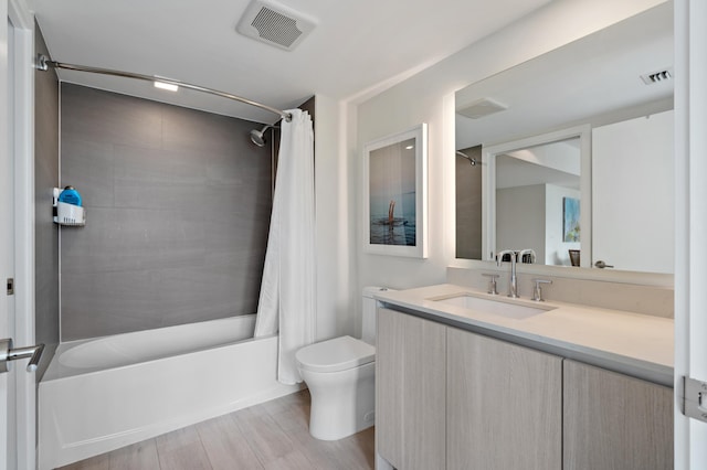 full bathroom with toilet, shower / bath combo, visible vents, and vanity