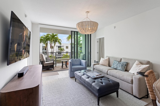 living room featuring a wall of windows, a notable chandelier, and wood finished floors