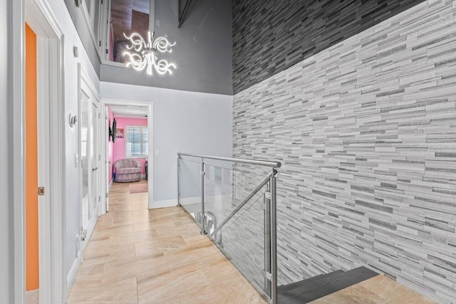 hallway featuring baseboards and an upstairs landing