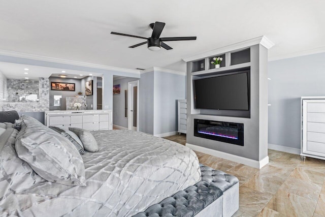 bedroom with ceiling fan, bar, baseboards, ornamental molding, and a glass covered fireplace