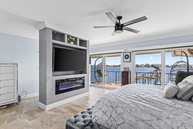 bedroom with access to exterior, a glass covered fireplace, crown molding, and baseboards