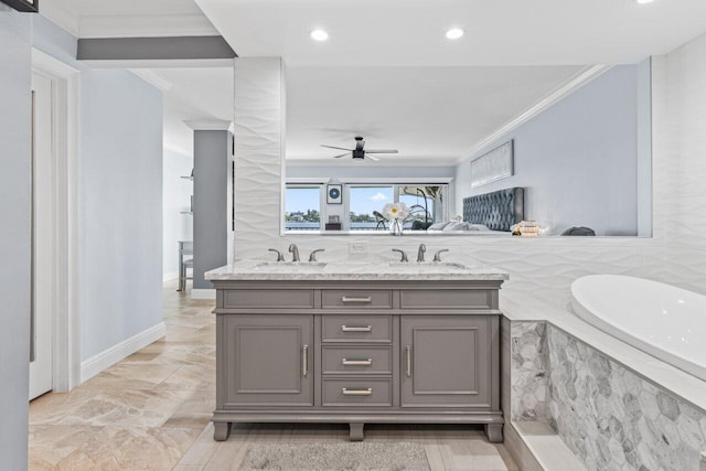 full bath featuring double vanity, a tub with marble appearance, a sink, and crown molding