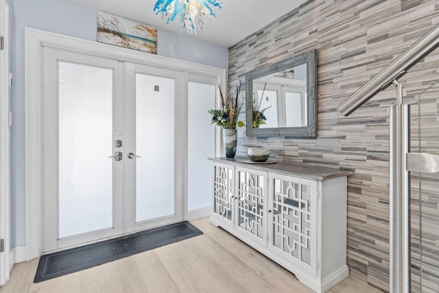 interior space with french doors and light wood-style flooring