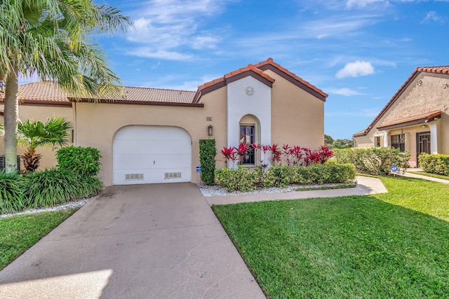 mediterranean / spanish home with a garage, a tile roof, concrete driveway, stucco siding, and a front yard