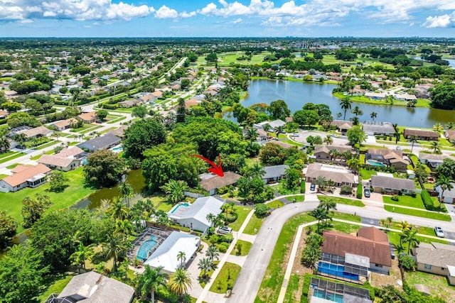 birds eye view of property with a residential view and a water view