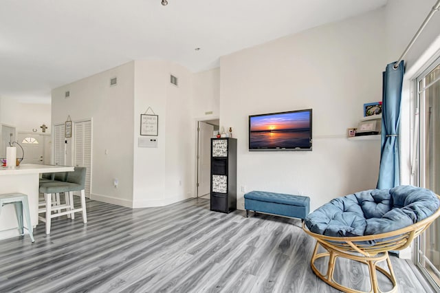 sitting room featuring baseboards, visible vents, and wood finished floors