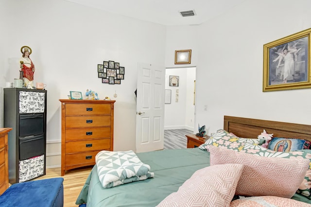 bedroom featuring light wood-style flooring and visible vents