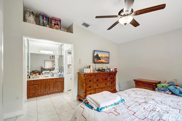 bedroom with lofted ceiling, visible vents, a ceiling fan, light tile patterned flooring, and connected bathroom