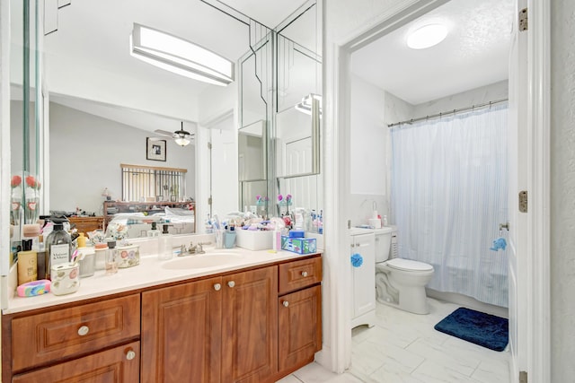 bathroom featuring a ceiling fan, vanity, toilet, and ensuite bathroom