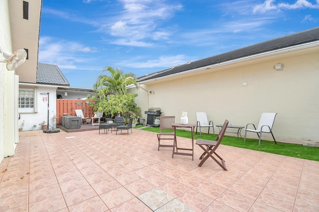 view of patio with fence and area for grilling