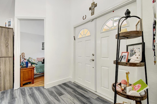 entryway featuring baseboards and wood finished floors