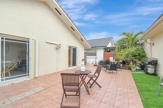 view of patio featuring fence and area for grilling