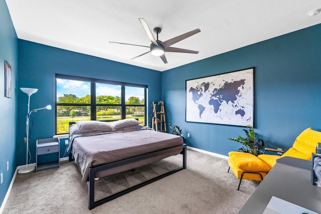 bedroom with a ceiling fan, baseboards, and carpet flooring