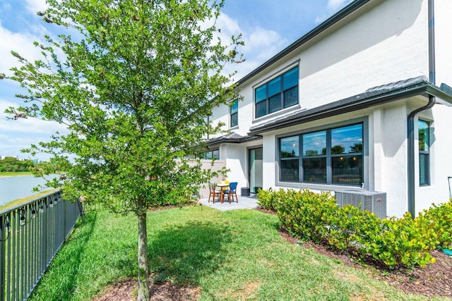 view of yard featuring central air condition unit, a fenced backyard, and a patio