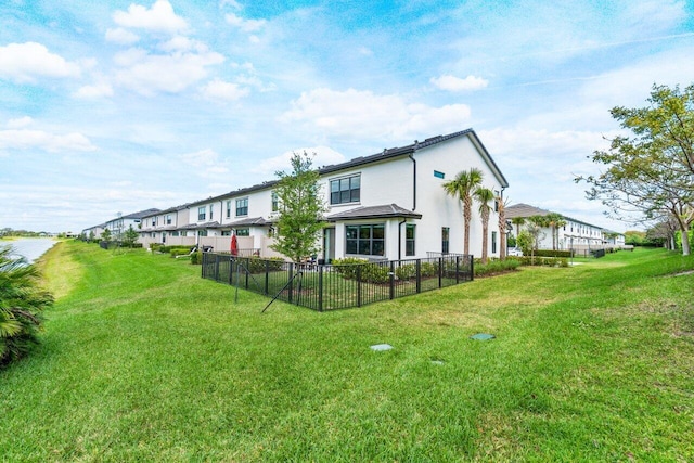 exterior space with a yard, fence, and stucco siding