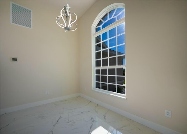 unfurnished room featuring a notable chandelier, visible vents, marble finish floor, and baseboards