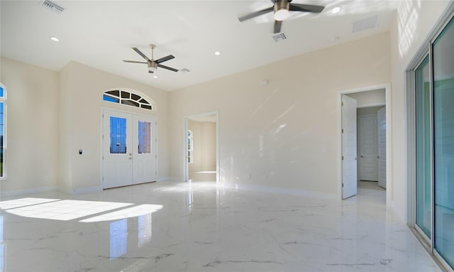 foyer entrance with visible vents, marble finish floor, baseboards, and ceiling fan