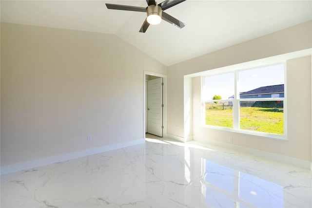 empty room featuring baseboards, lofted ceiling, marble finish floor, and ceiling fan