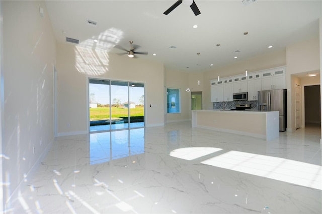 interior space featuring recessed lighting, visible vents, marble finish floor, and baseboards