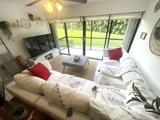 living room featuring a sunroom and a ceiling fan