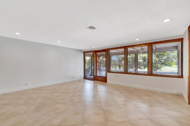 spare room featuring recessed lighting, visible vents, plenty of natural light, and baseboards