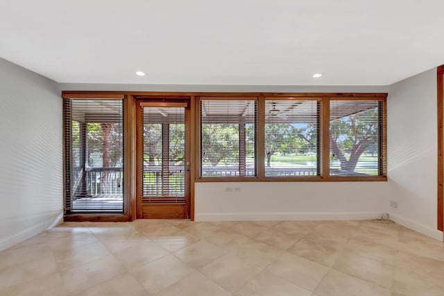 entryway with baseboards and recessed lighting