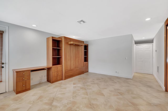 unfurnished living room featuring recessed lighting, visible vents, baseboards, and built in study area