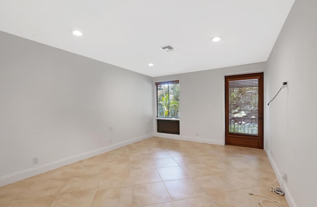 unfurnished room featuring light tile patterned floors, visible vents, baseboards, and recessed lighting