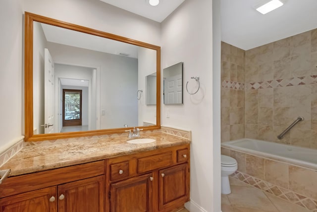 full bath featuring toilet, tile patterned flooring, tiled shower / bath combo, and vanity