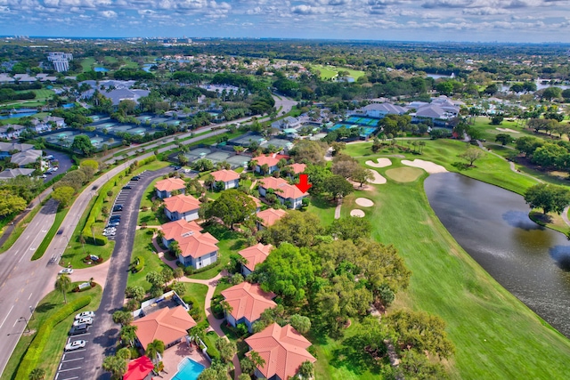 bird's eye view with golf course view, a water view, and a residential view