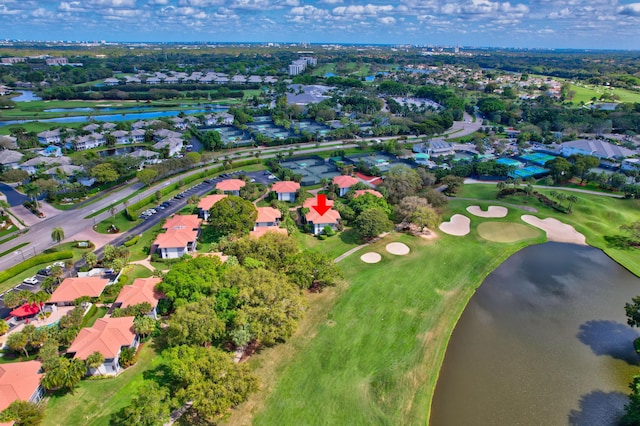 drone / aerial view with golf course view, a water view, and a residential view