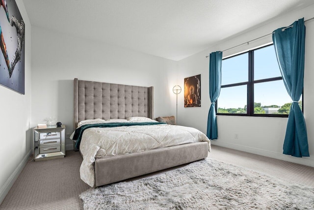 carpeted bedroom with baseboards