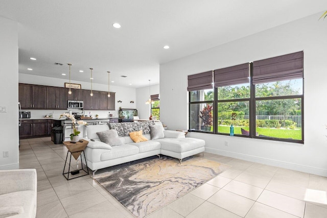 living room with recessed lighting, baseboards, and light tile patterned floors