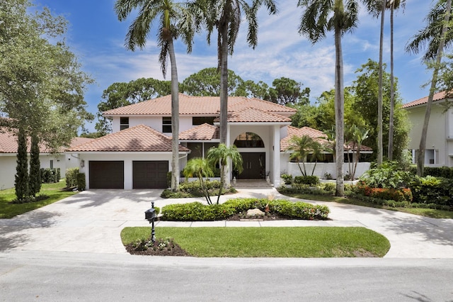 mediterranean / spanish house with a garage, concrete driveway, a tile roof, fence, and stucco siding