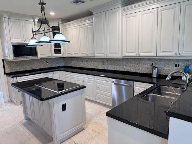 3271 Harrington Dr, Boca Raton, FL 33496 - kitchen featuring appliances with stainless steel finishes, a sink, tasteful backsplash, white cabinetry, and recessed lighting