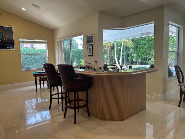 3271 Harrington Dr, Boca Raton, FL 33496 - bar featuring vaulted ceiling and baseboards